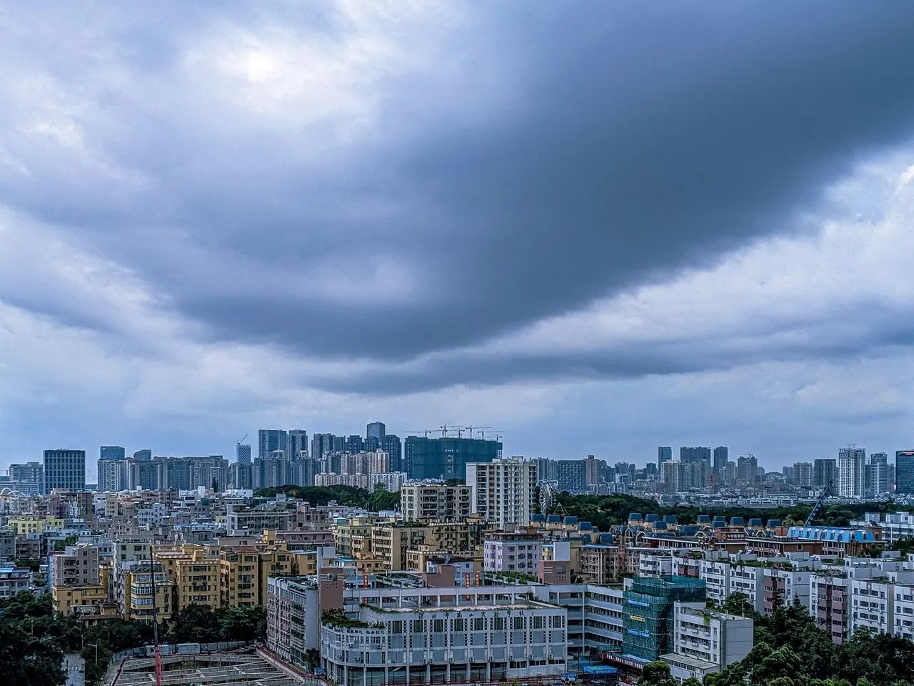 City skyline under a stormy, overcast sky.